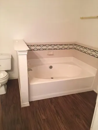 a bathroom with a bathtub and toilet