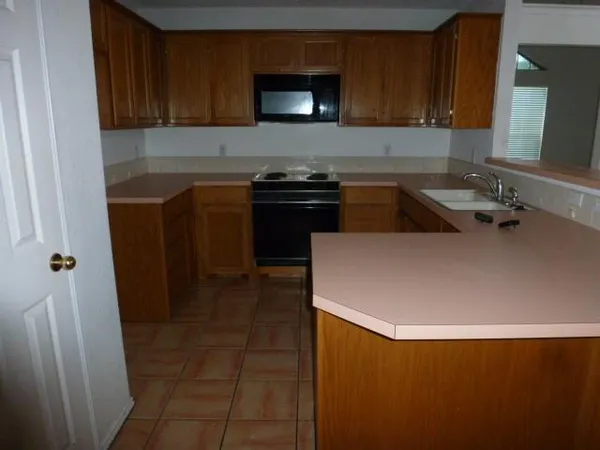 a kitchen with a sink and a stove top oven
