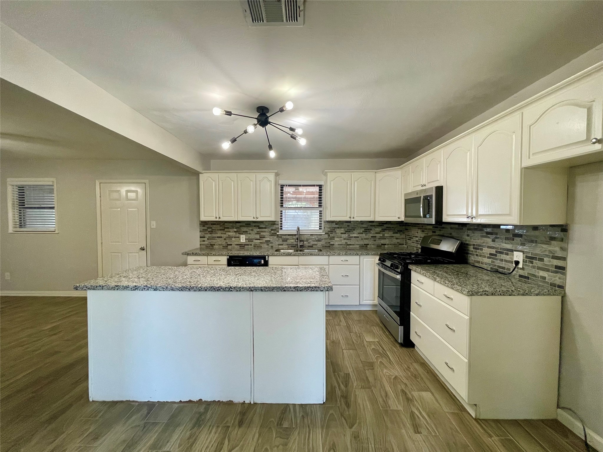 300 Hargett Street Clute, TX 77531 - Photo 11 of 36 a kitchen with stainless steel appliances granite countertop a sink and cabinets