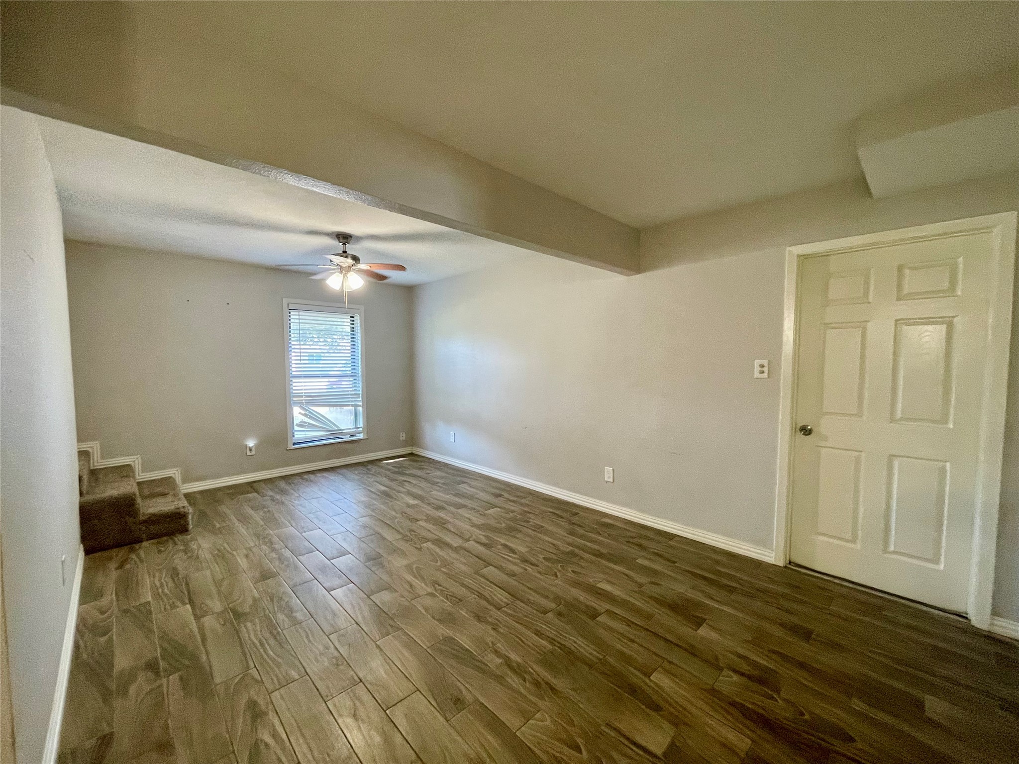 300 Hargett Street Clute, TX 77531 - Photo 13 of 36 a view of empty room with wooden floor and fan