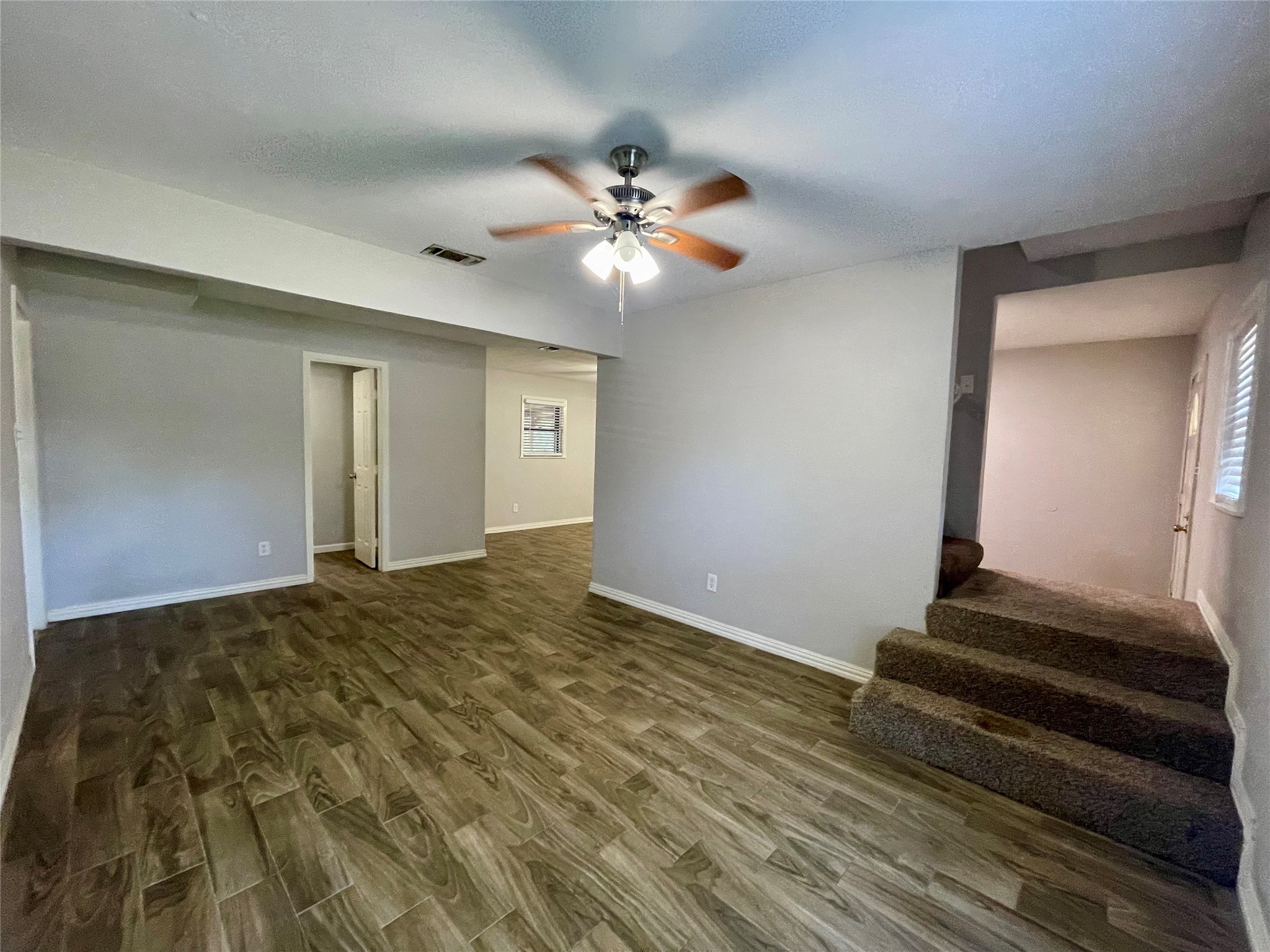 300 Hargett Street Clute, TX 77531 - Photo 15 of 36 a view of a livingroom with wooden floor and ceiling fan