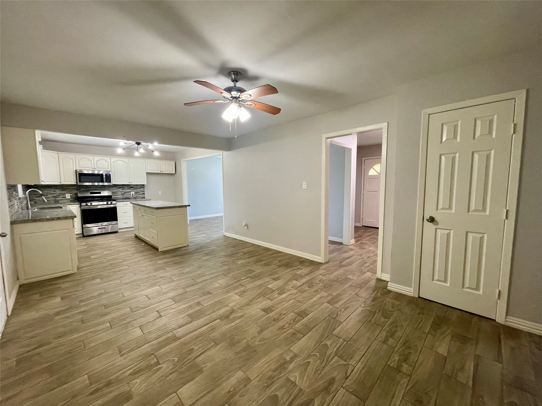 300 Hargett Street Clute, TX 77531 - Photo 22 of 36 a view of empty room with wooden floor and ceiling fan