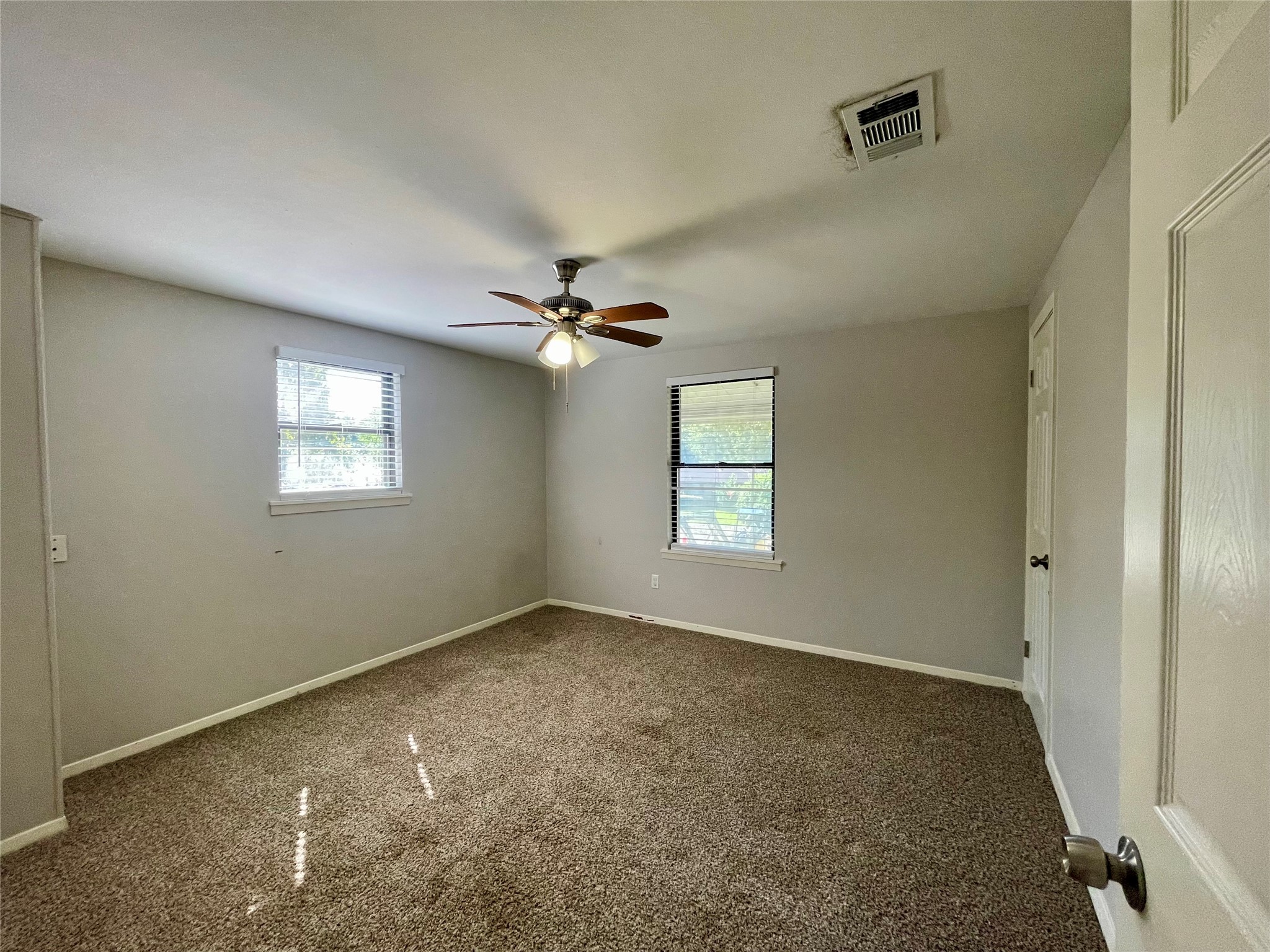 300 Hargett Street Clute, TX 77531 - Photo 26 of 36 a view of a big room with windows and chandelier fan