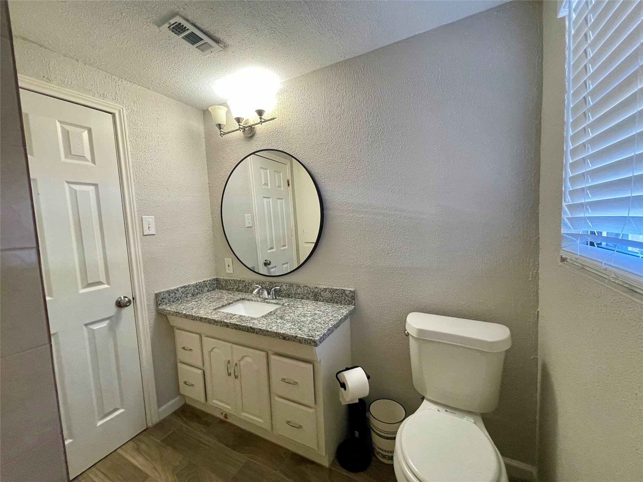 300 Hargett Street Clute, TX 77531 - Photo 32 of 36 a bathroom with a toilet sink vanity granite and mirror