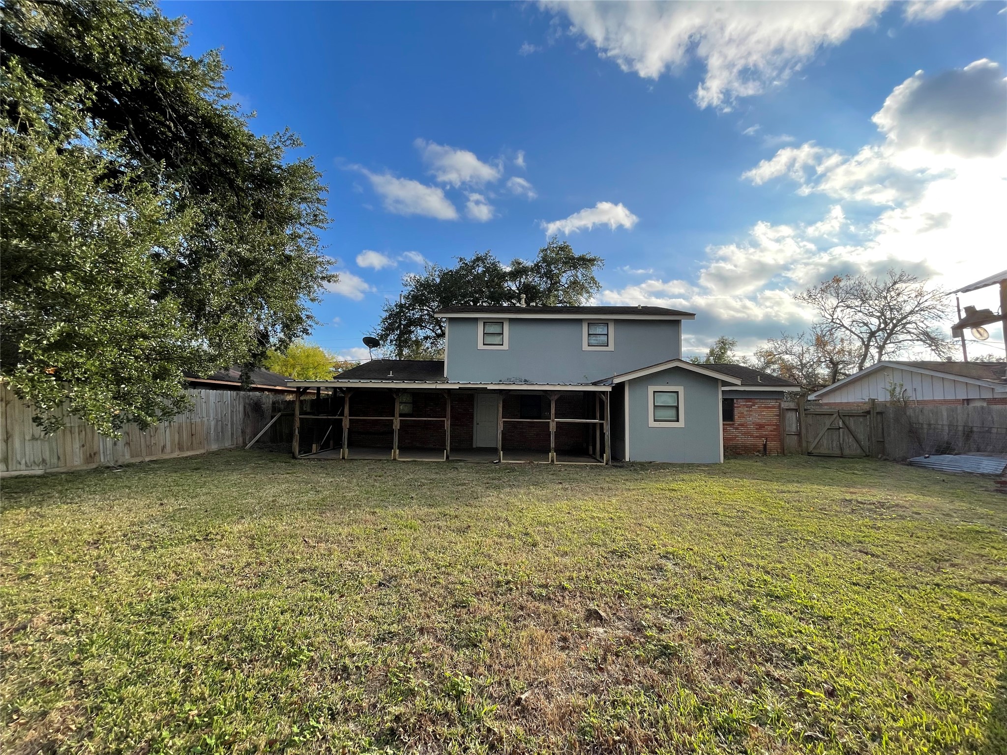 300 Hargett Street Clute, TX 77531 - Photo 35 of 36 a view of a house with a yard and covered with wooden fence
