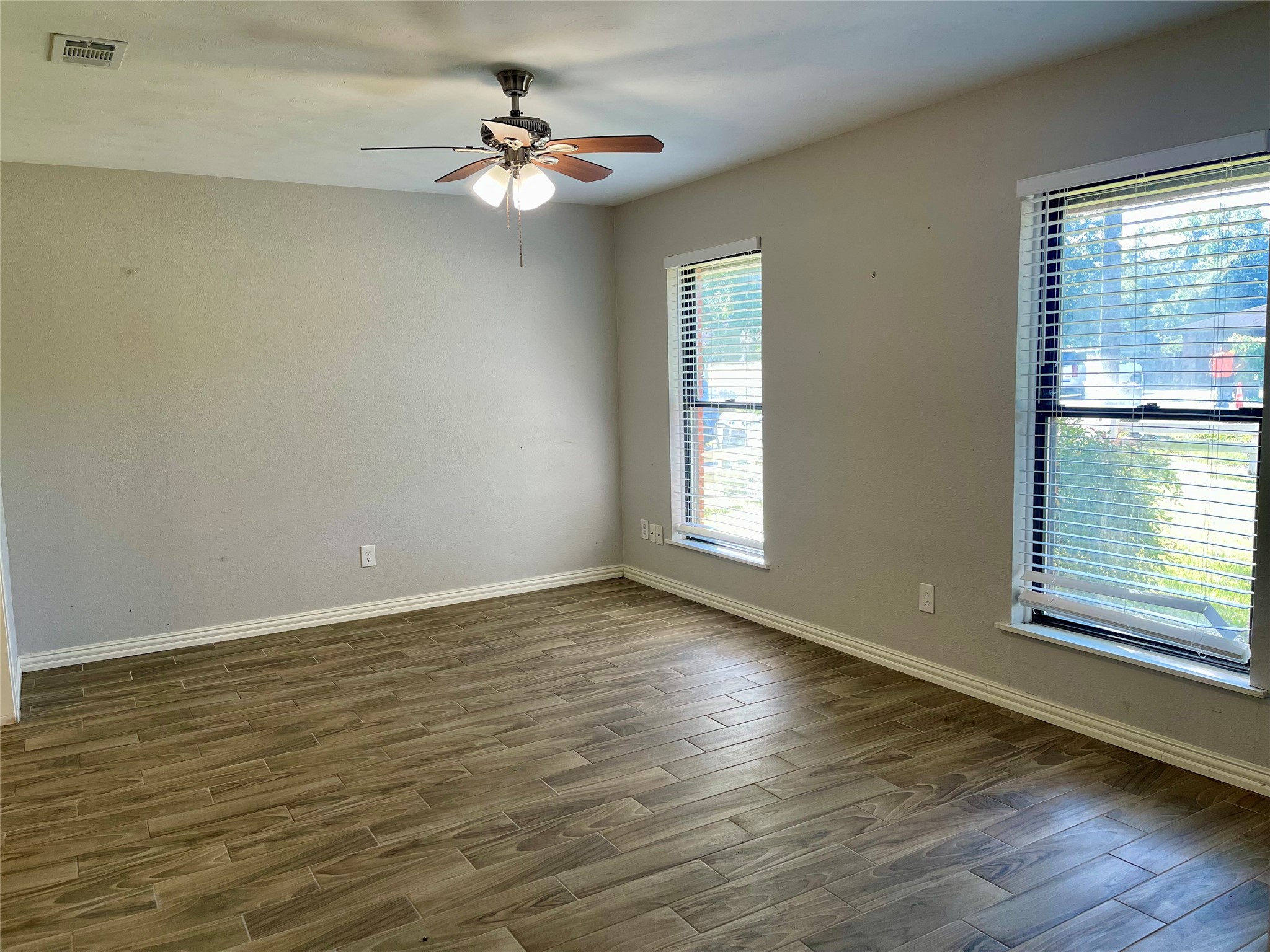 300 Hargett Street Clute, TX 77531 - Photo 5 of 36 a view of an empty room with wooden floor and a window