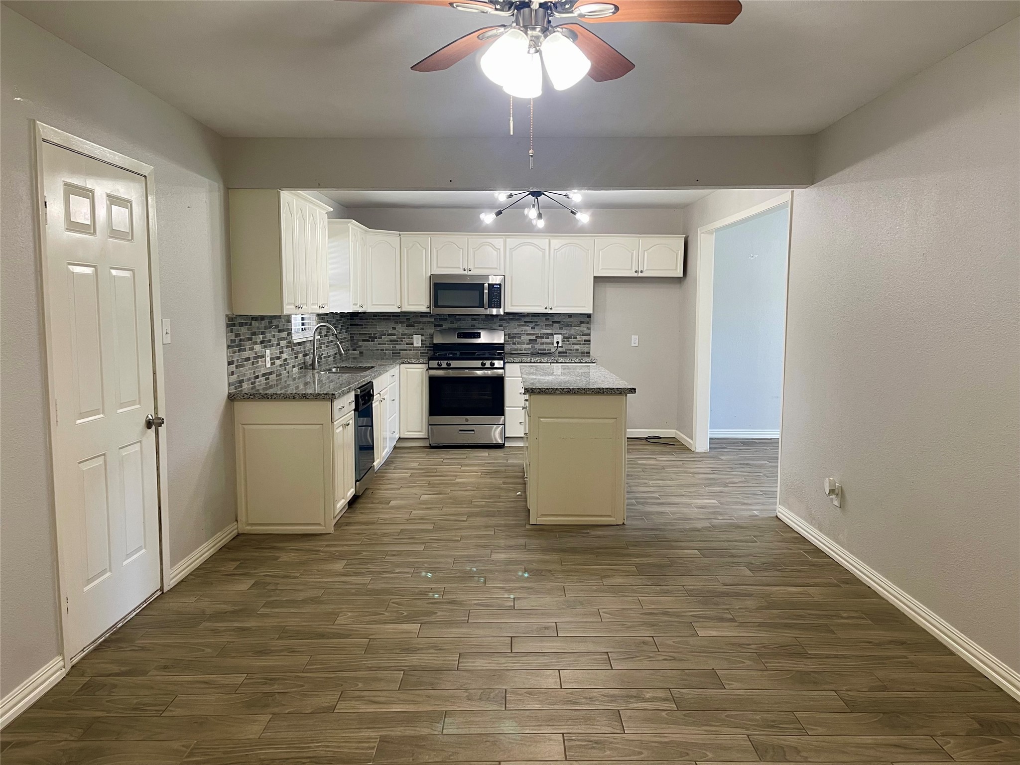 300 Hargett Street Clute, TX 77531 - Photo 7 of 36 a large white kitchen with a stove a sink dishwasher and a refrigerator