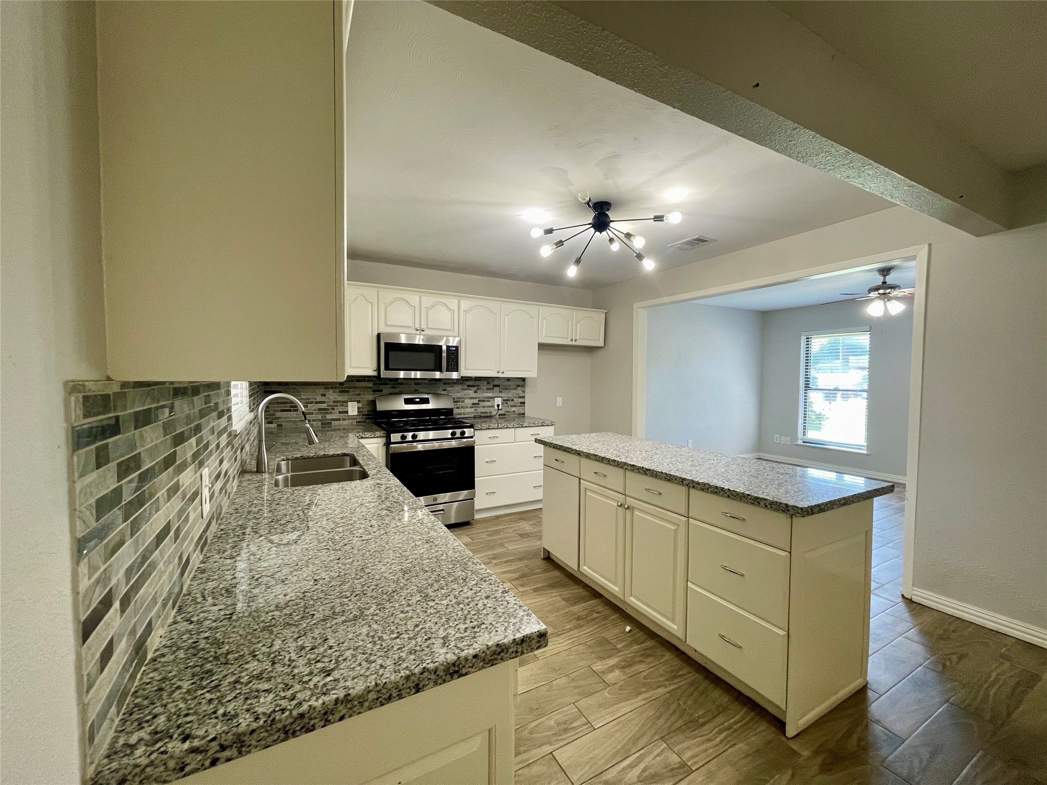 300 Hargett Street Clute, TX 77531 - Photo 9 of 36 a kitchen with stainless steel appliances granite countertop a sink stove and cabinets
