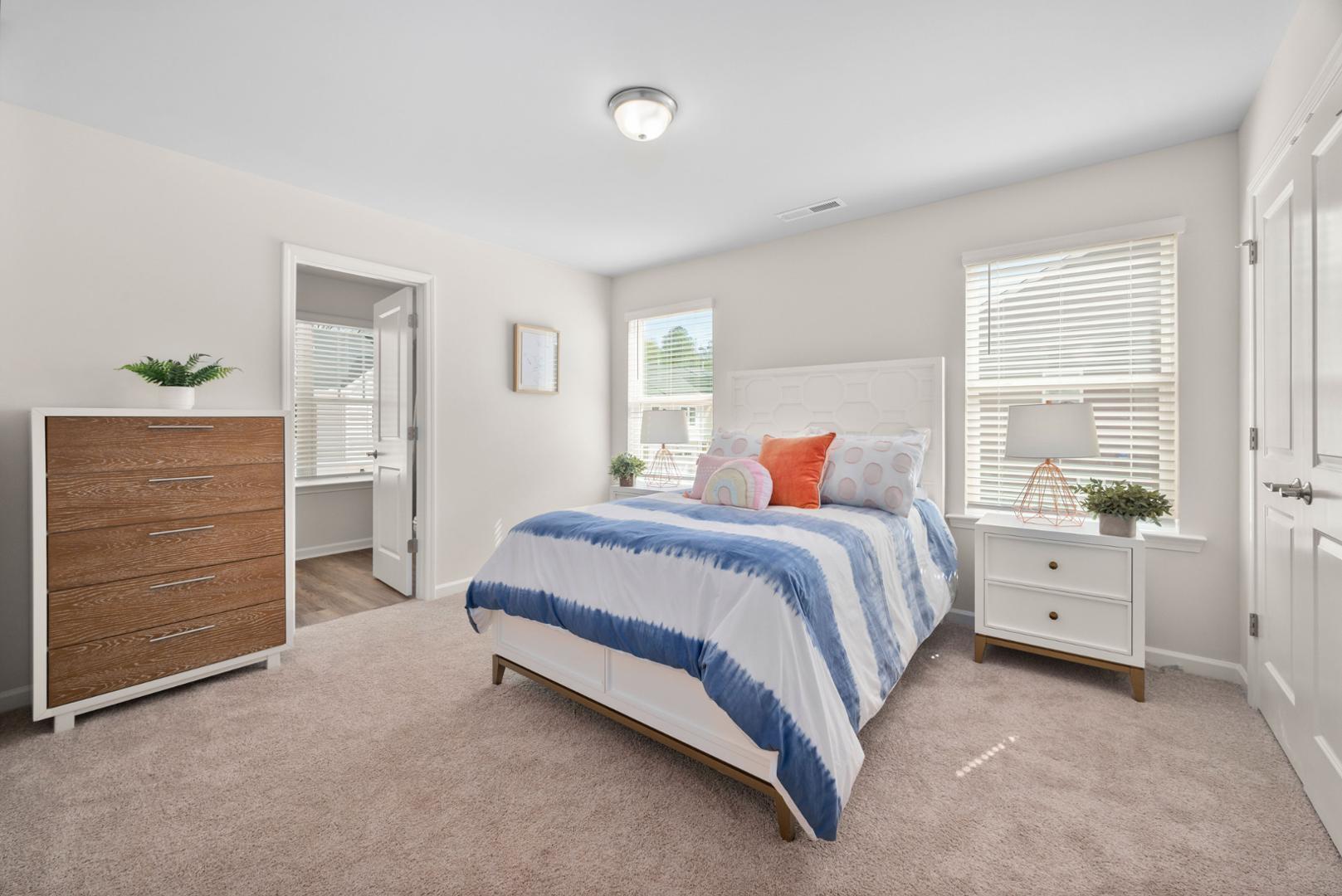 7610 Waypond Court Raleigh, NC 27617 - Photo 5 of 13 a spacious bedroom with a bed and a window