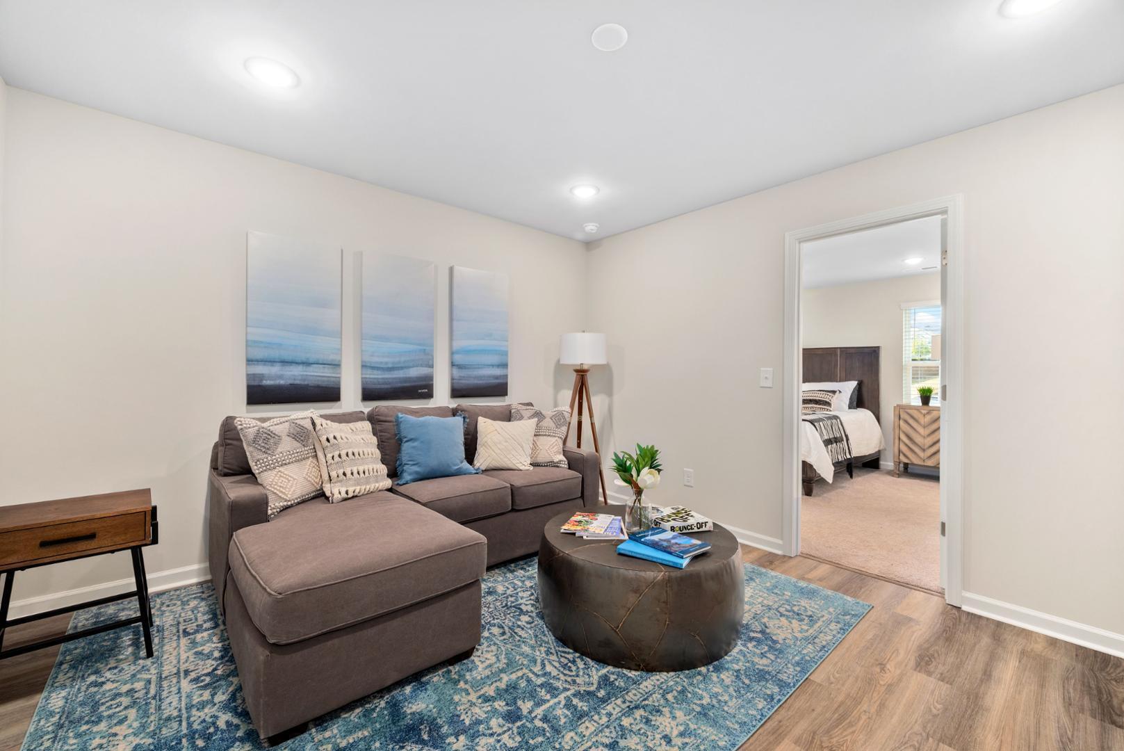 7610 Waypond Court Raleigh, NC 27617 - Photo 10 of 13 a living room with furniture and a potted plant