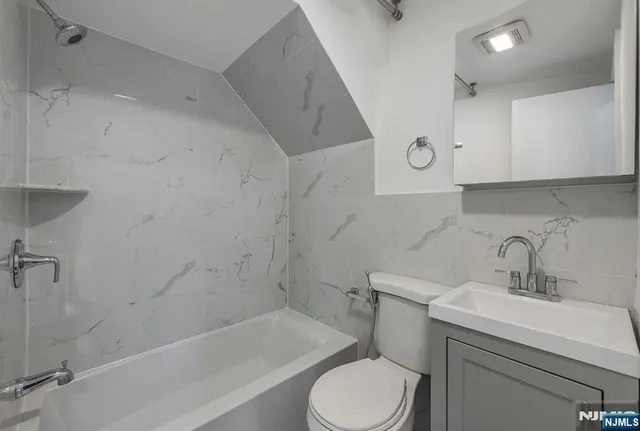 a bathroom with a sink toilet and bathtub