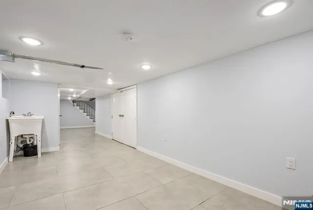 an empty room with a fireplace and a window