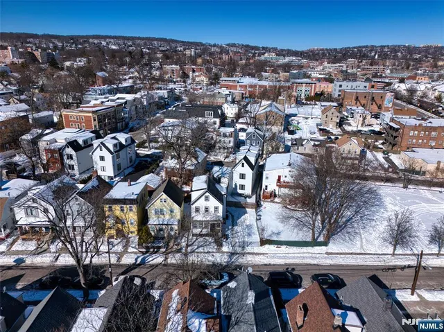 an aerial view of a house with a yard
