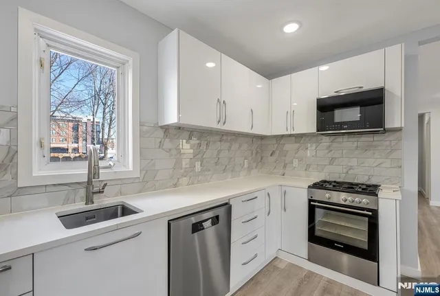 a kitchen with a sink stove and microwave