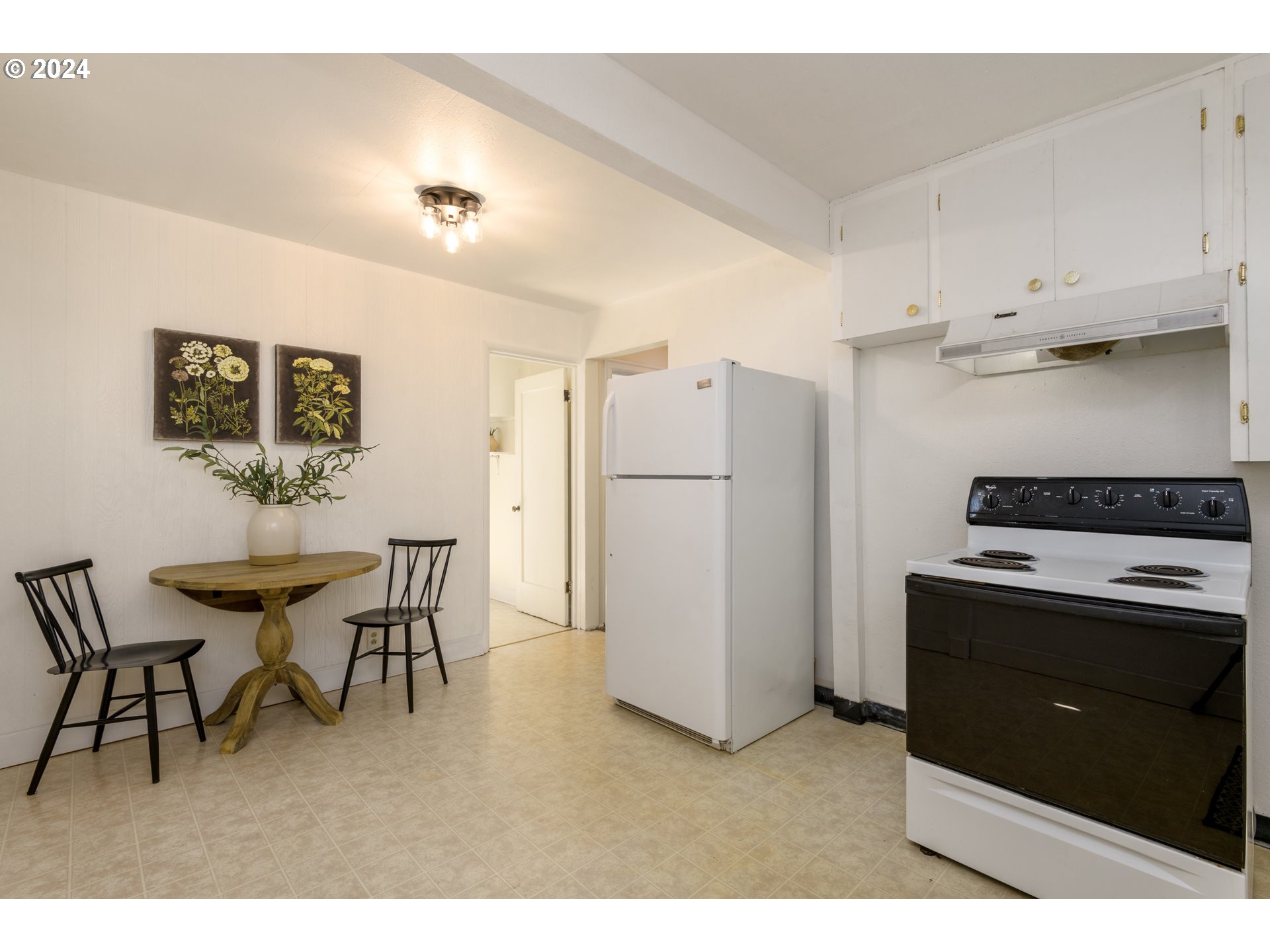 1476 West 4th Avenue Eugene, OR 97402 - Photo 11 of 26 a kitchen with refrigerator and cabinets