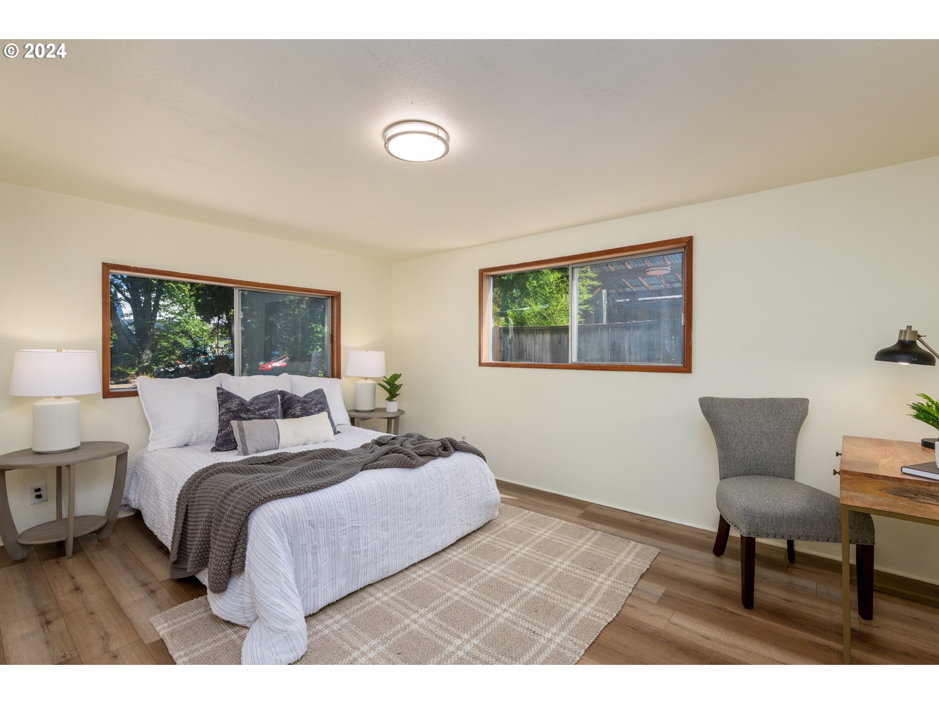 1476 West 4th Avenue Eugene, OR 97402 - Photo 13 of 26 a bedroom with a bed a mirror and a window