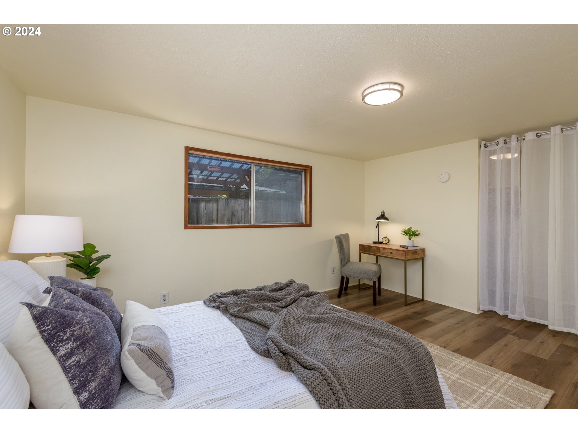 1476 West 4th Avenue Eugene, OR 97402 - Photo 14 of 26 a bedroom with a bed and a window