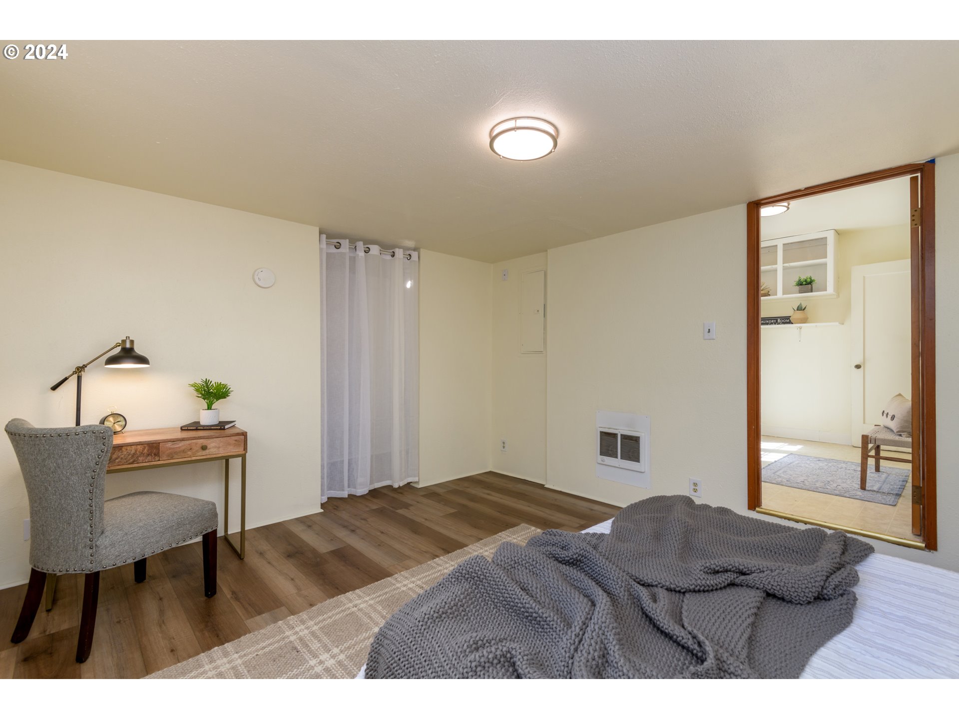 1476 West 4th Avenue Eugene, OR 97402 - Photo 15 of 26 a bedroom with a bed and a table in it