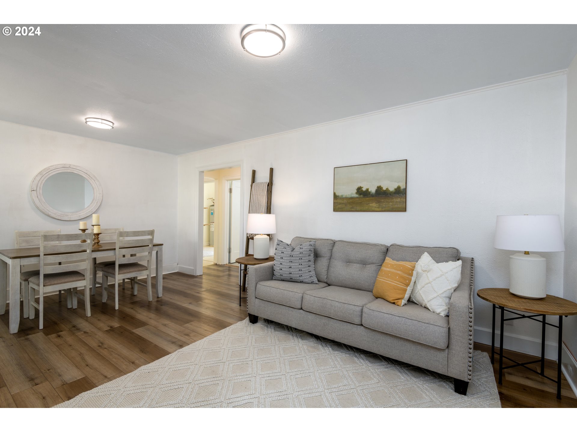 1476 West 4th Avenue Eugene, OR 97402 - Photo 7 of 26 a living room with furniture a wooden floor and a lamp