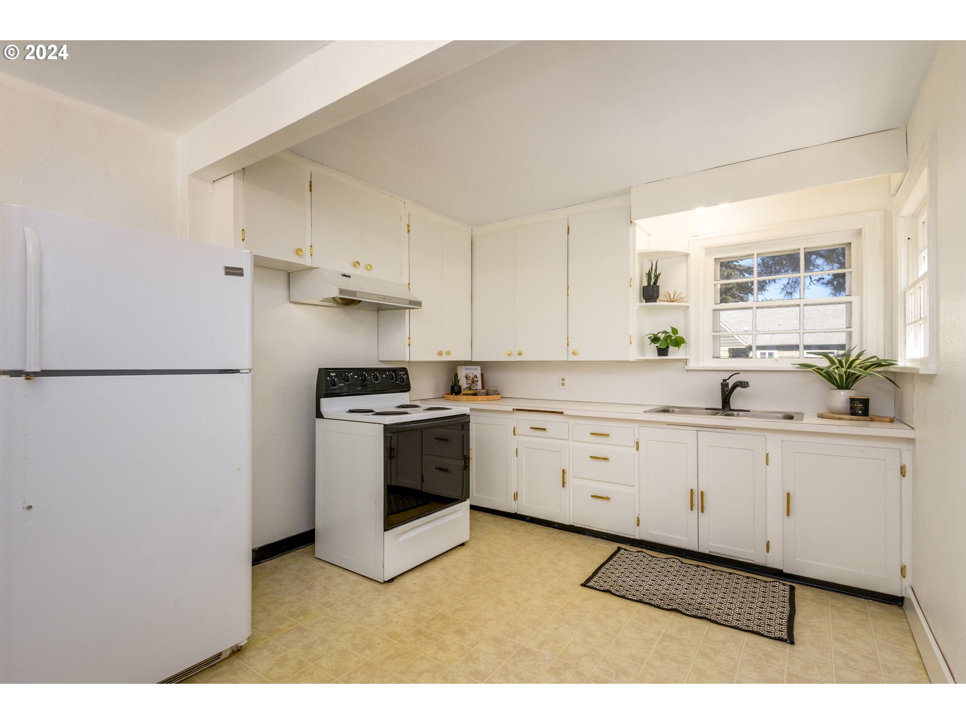 1476 West 4th Avenue Eugene, OR 97402 - Photo 10 of 26 a kitchen with granite countertop white cabinets and white appliances