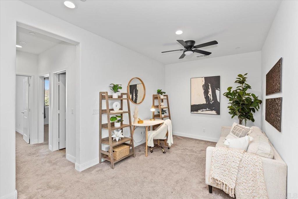 2465 Solara Lane Vista, CA 92081 - Photo 17 of 48 a living room with furniture and a chandelier