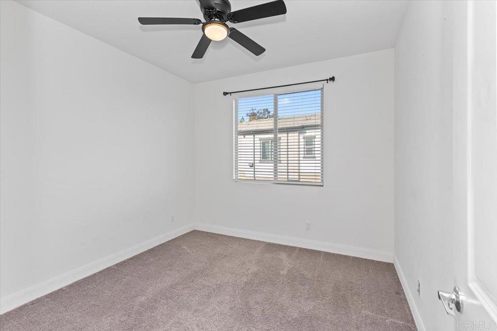 2465 Solara Lane Vista, CA 92081 - Photo 22 of 48 an empty room with a window and a fan