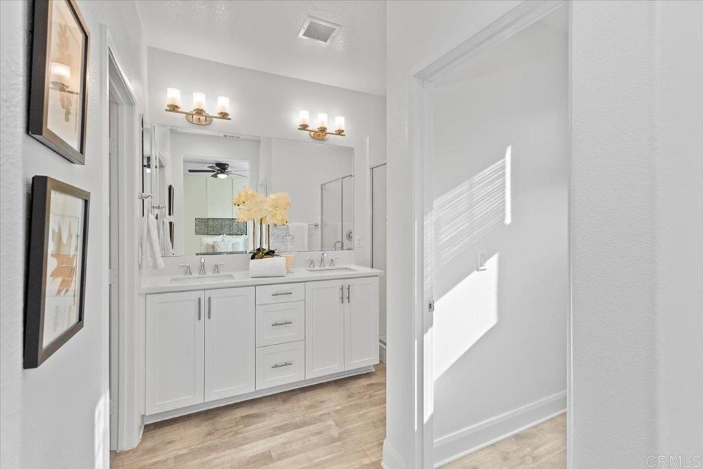 2465 Solara Lane Vista, CA 92081 - Photo 26 of 48 a bathroom with a double vanity sink and a mirror