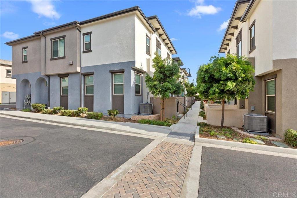 2465 Solara Lane Vista, CA 92081 - Photo 30 of 48 a front view of a house with a yard and garage