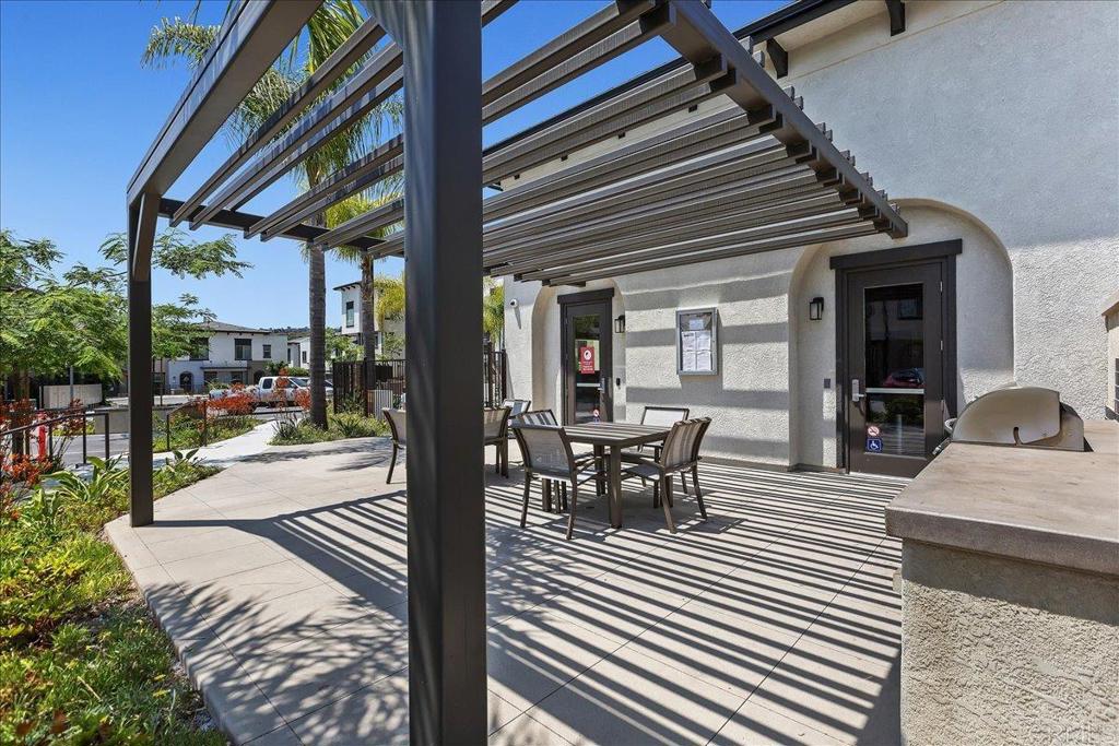 2465 Solara Lane Vista, CA 92081 - Photo 45 of 48 a view of a patio with table and chairs and floor to ceiling windows