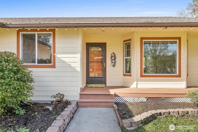 a view of a big room with wooden floor and windows