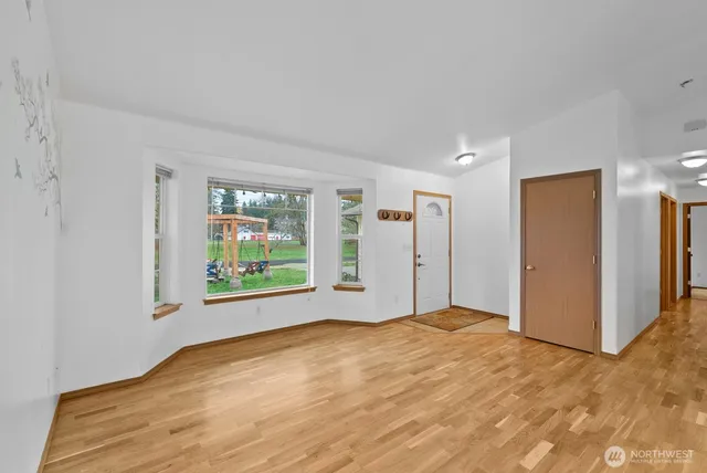 a view of an entryway with wooden floor and cabinet