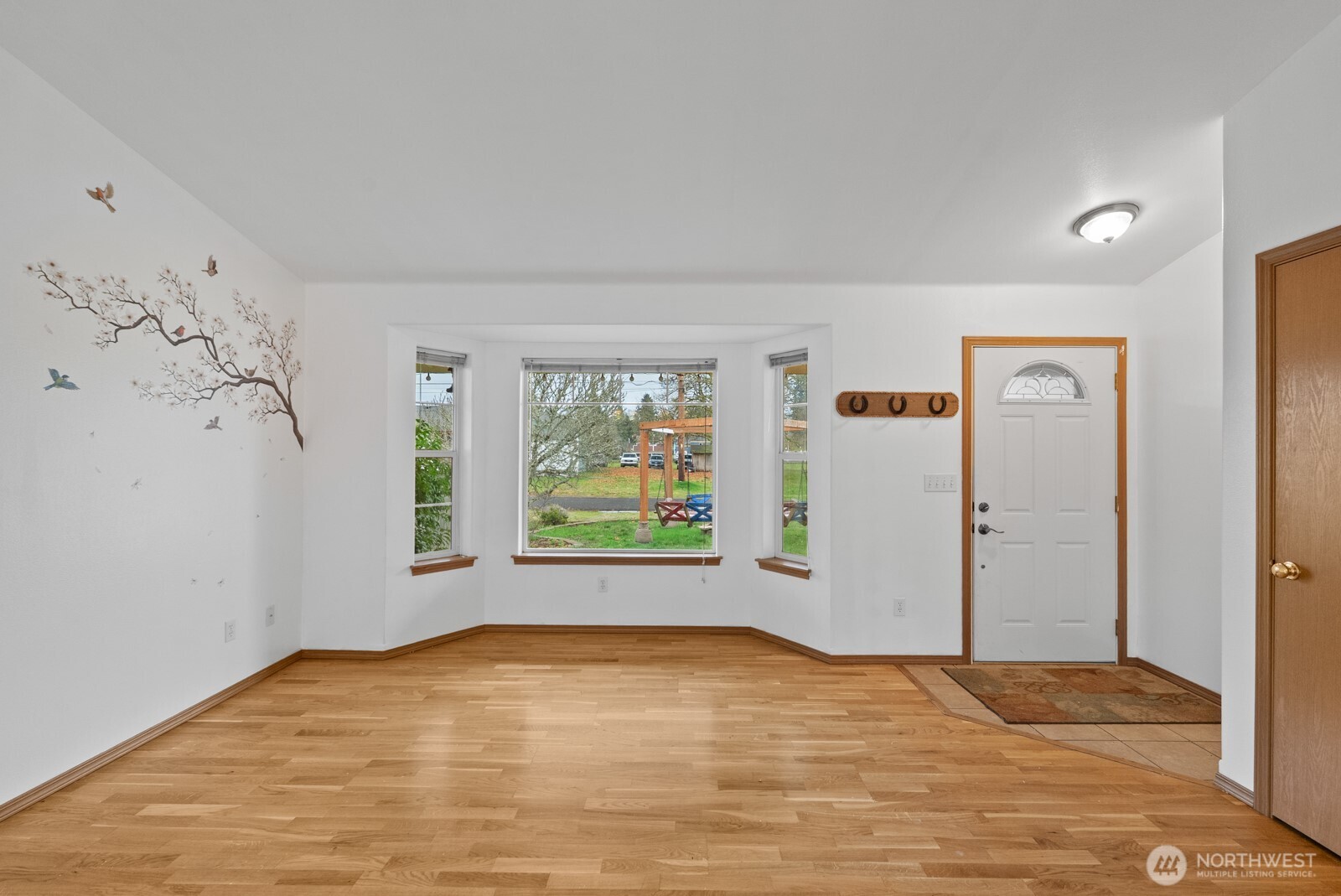 215 James Street Roy, WA 98580 - Photo 7 of 26 a view of empty room with window and wooden floor