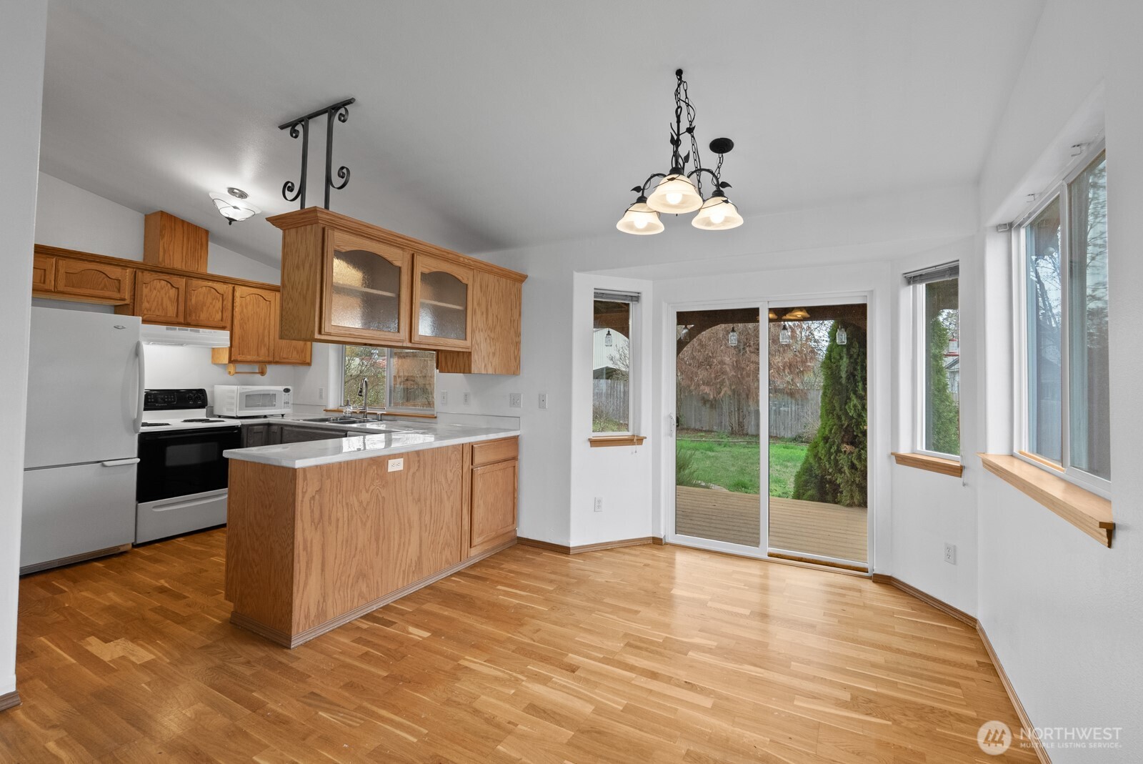 215 James Street Roy, WA 98580 - Photo 10 of 26 a kitchen with stainless steel appliances granite countertop a stove a refrigerator a sink and dishwasher with wooden floor