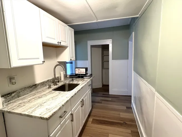 a kitchen with sink cabinets and stove