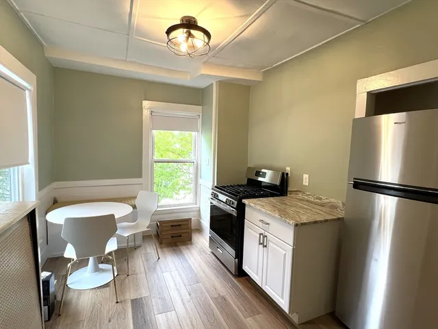 a kitchen with a stove a sink and a refrigerator