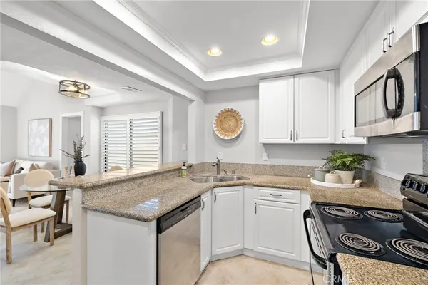 a kitchen with a stove a sink and a refrigerator