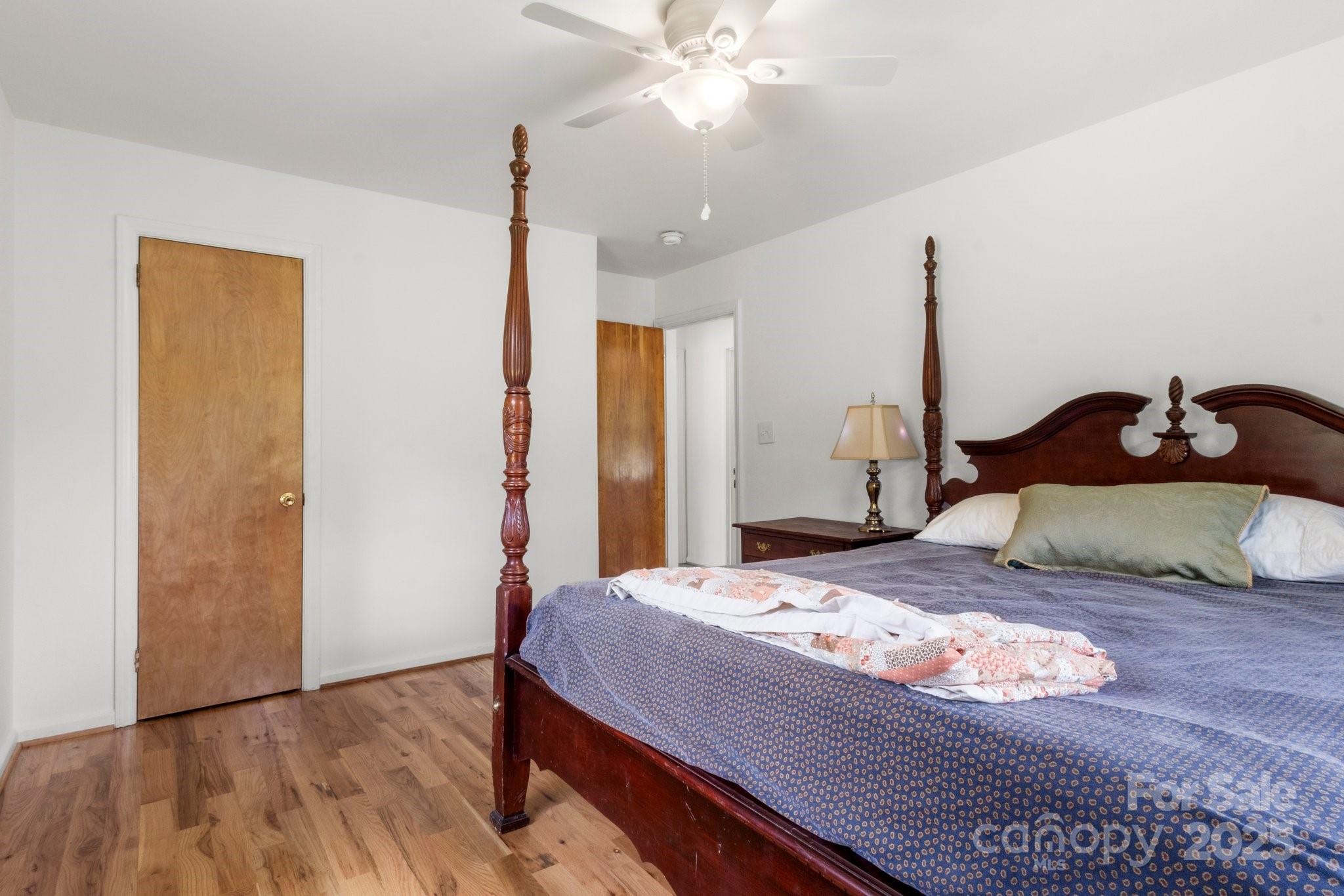 1725 Fallston Road Shelby, NC 28150 - Photo 20 of 35 a bedroom with a large bed and a chandelier