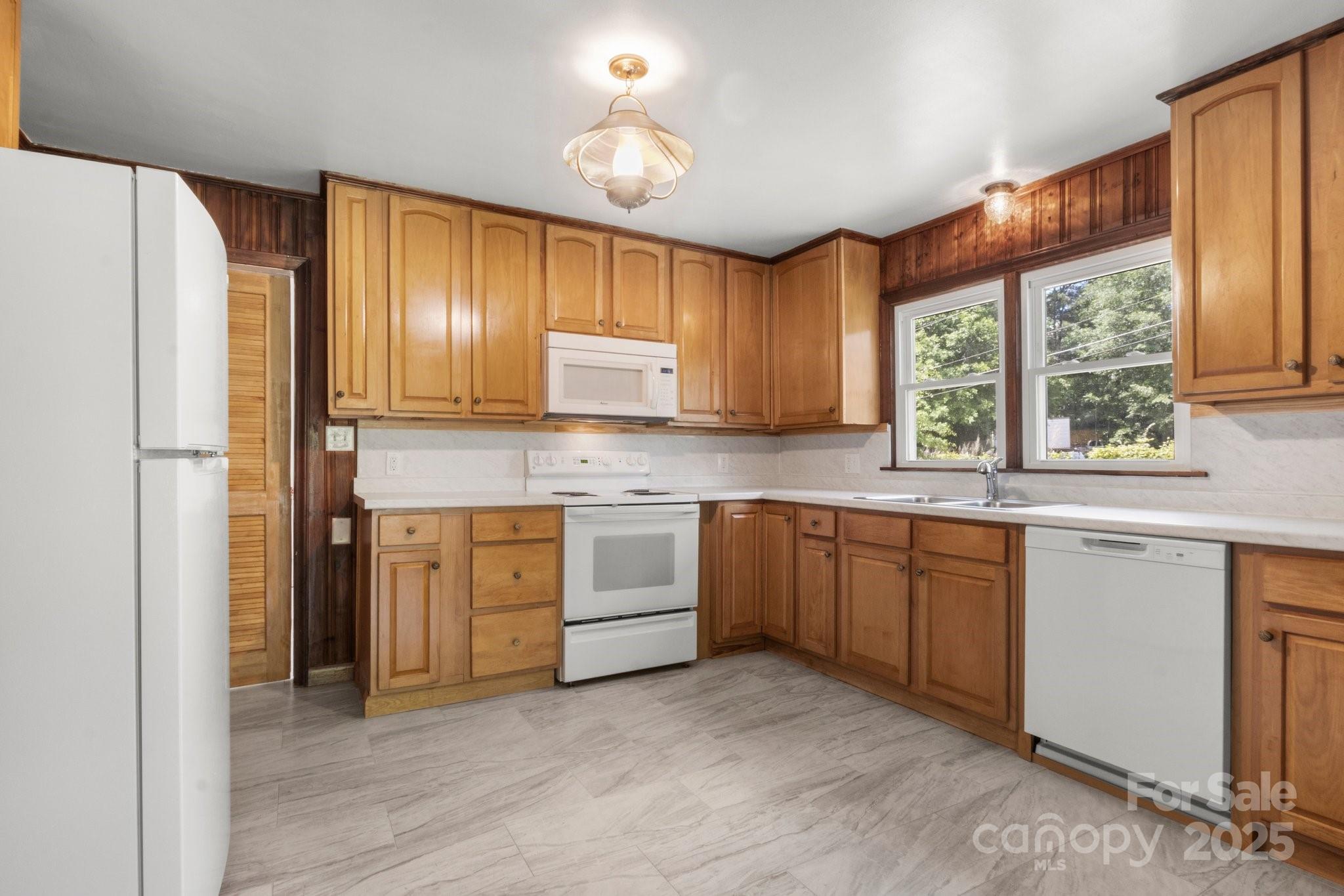 1725 Fallston Road Shelby, NC 28150 - Photo 10 of 35 a kitchen with a stove a sink and a refrigerator