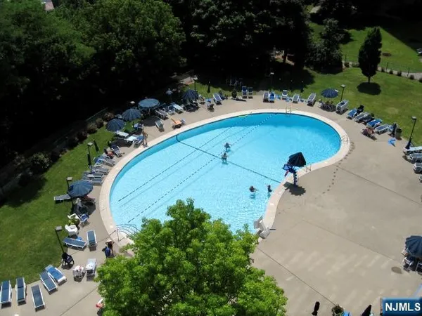 an aerial view of a house with yard swimming pool and outdoor seating