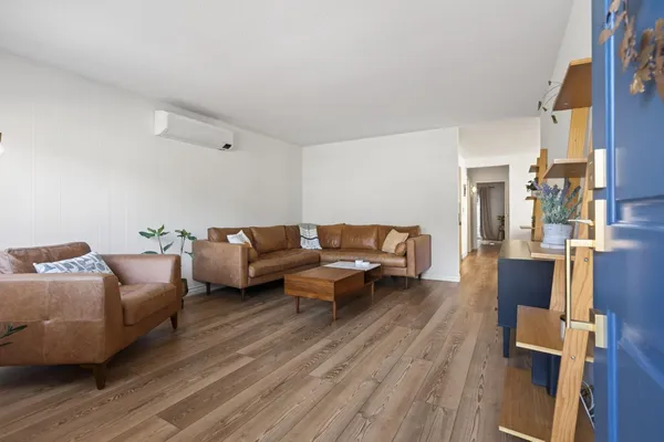 a living room with furniture or couch and a wooden floor