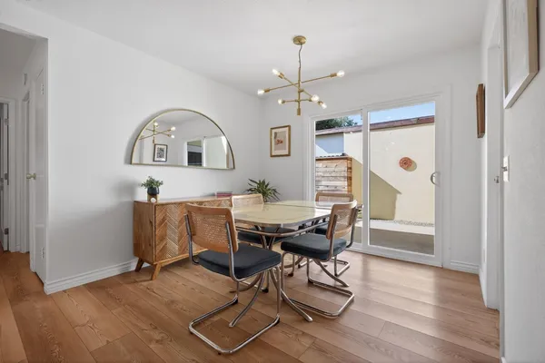 a view of a dining room with furniture window and wooden floor