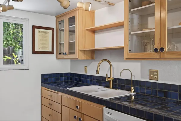 a kitchen with stainless steel appliances granite countertop a sink a stove and a granite counter tops with a window