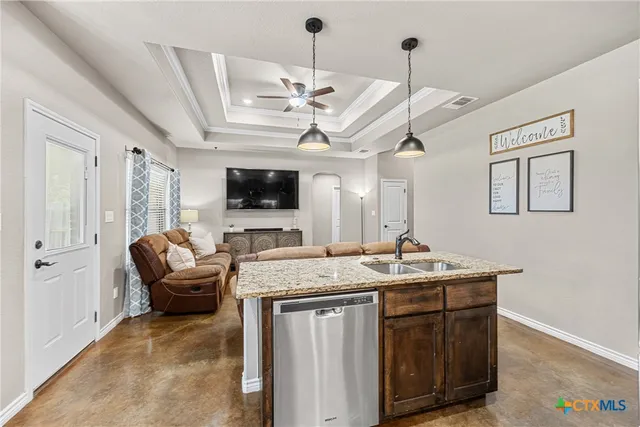 a kitchen with a stove a sink and a refrigerator