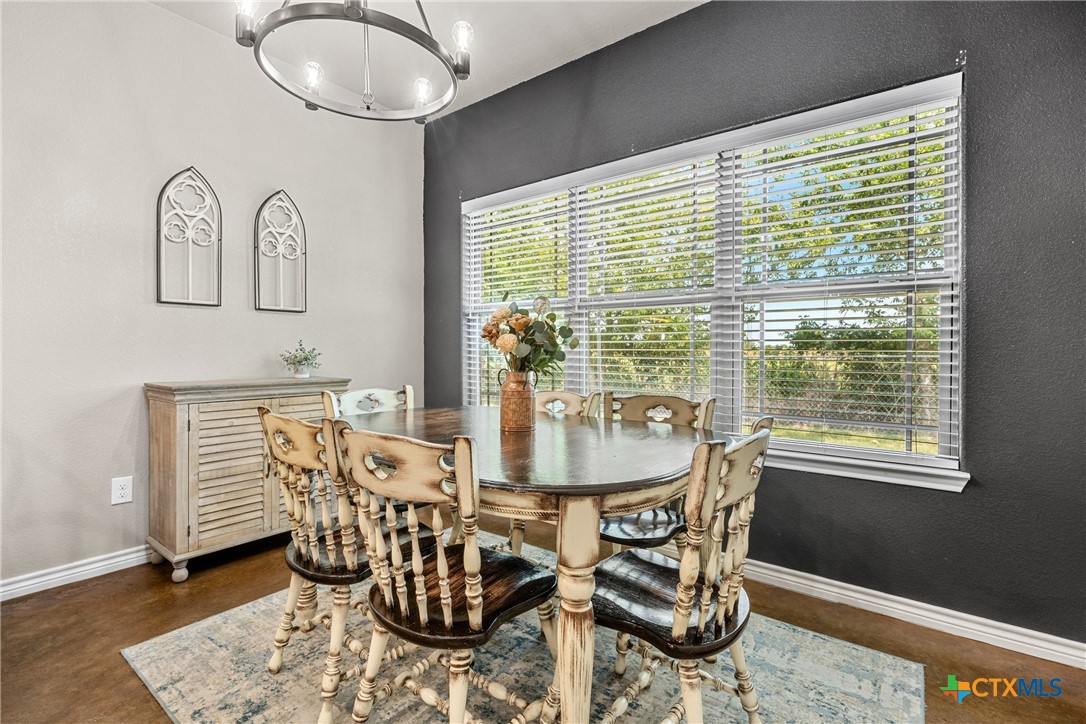 7112 Kc Ranch Court Temple, TX 76501 - Photo 14 of 30 a dining room table with wooden floor and windows
