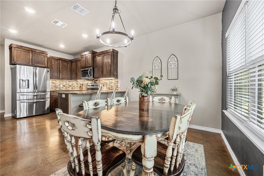 7112 Kc Ranch Court Temple, TX 76501 - Photo 15 of 30 a dining room with furniture a chandelier and wooden floor