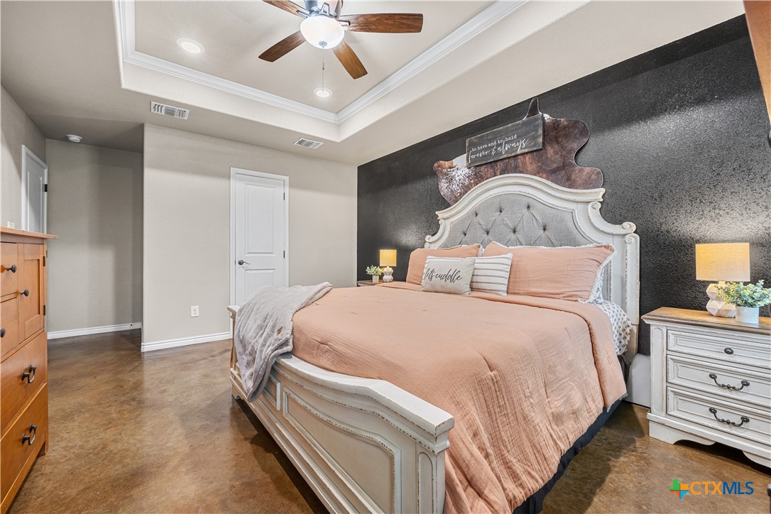 7112 Kc Ranch Court Temple, TX 76501 - Photo 16 of 30 a spacious bedroom with a bed and a chandelier