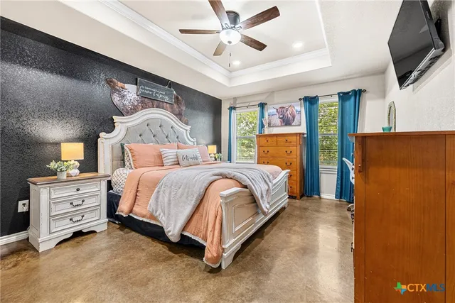 a bedroom with a bed dresser and flat screen tv