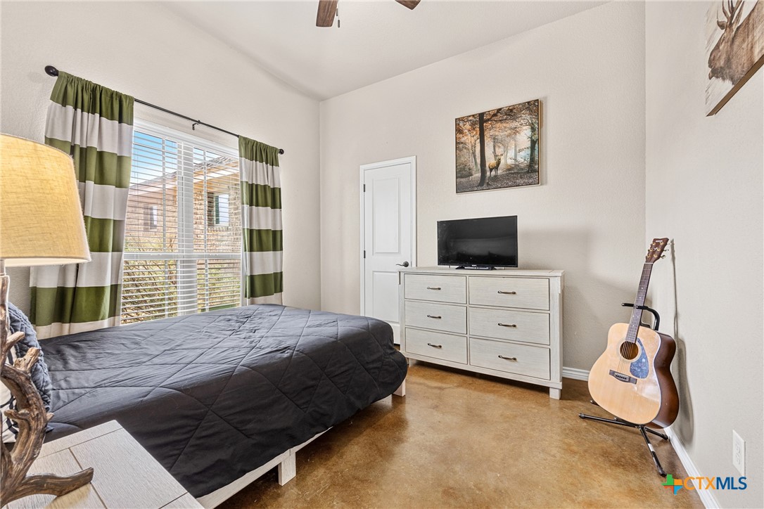 7112 Kc Ranch Court Temple, TX 76501 - Photo 21 of 30 a bedroom with a bed a flat screen tv and dresser