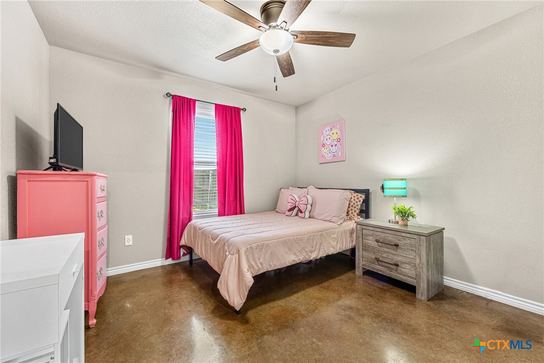 7112 Kc Ranch Court Temple, TX 76501 - Photo 23 of 30 a bedroom with a bed and a flat screen tv