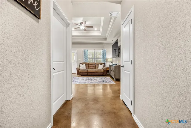 a view of hallway with livingroom and furniture